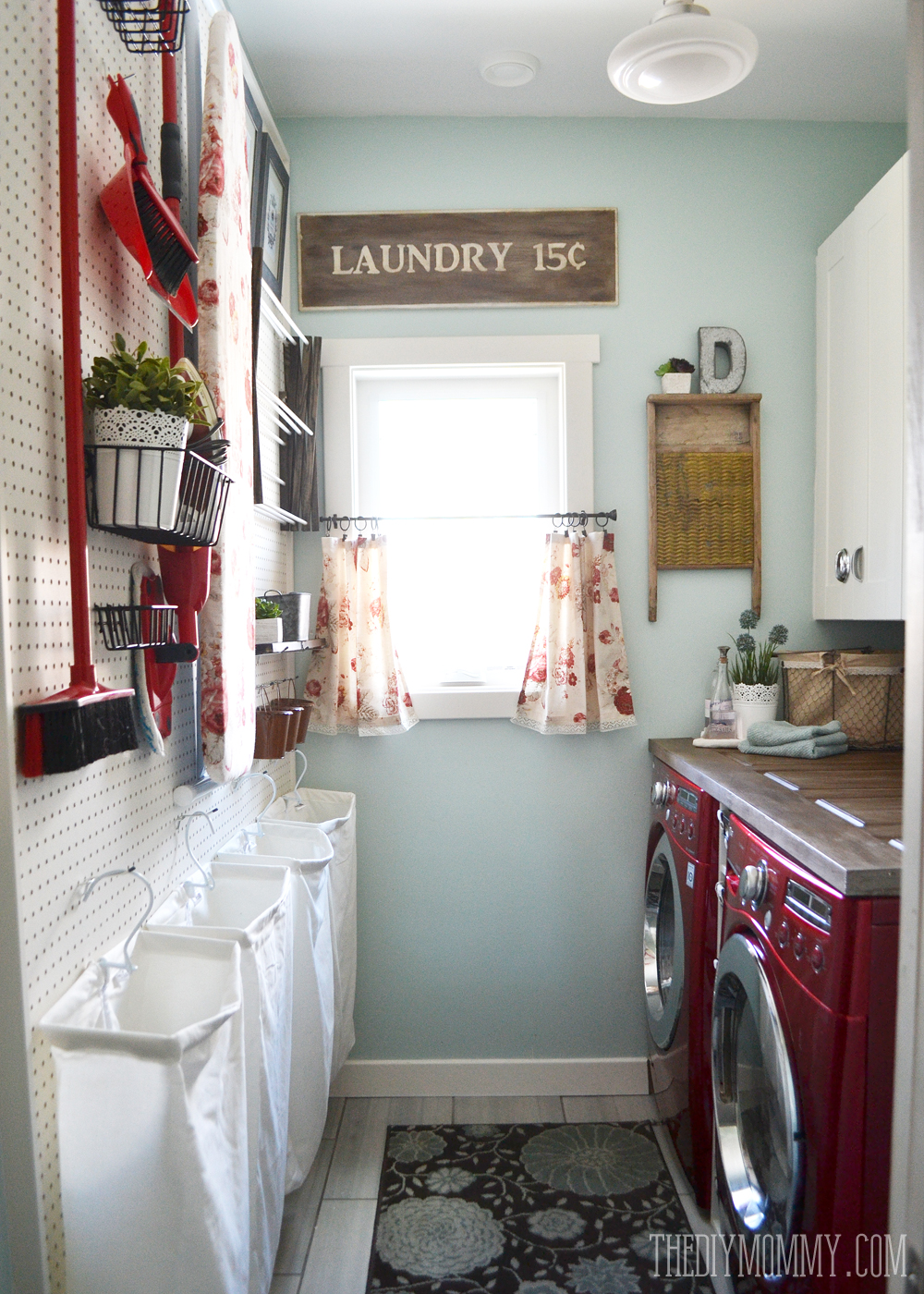 DIY aqua & red vintage inspired small laundry room design idea with a giant pegboard
